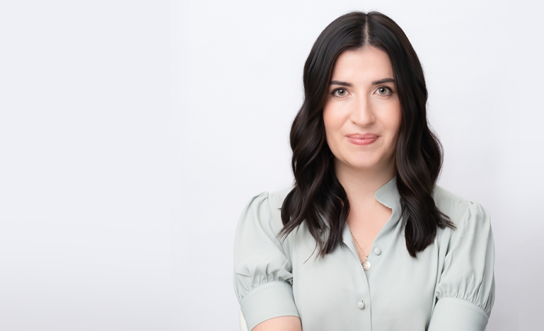 Head-shot photo of OBA President Katy Commisso in light grey, short-sleeved blouse, smiling into camera