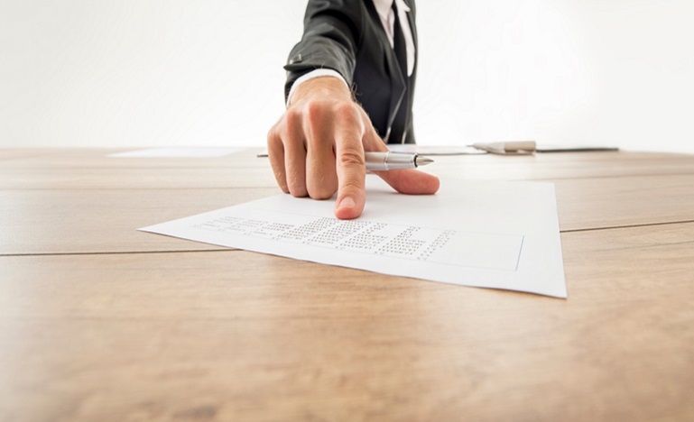 photo of a male hand pointing at a draft expert witness report
