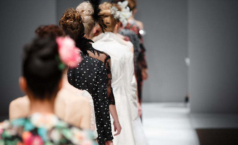 line of women on a fashion show runway