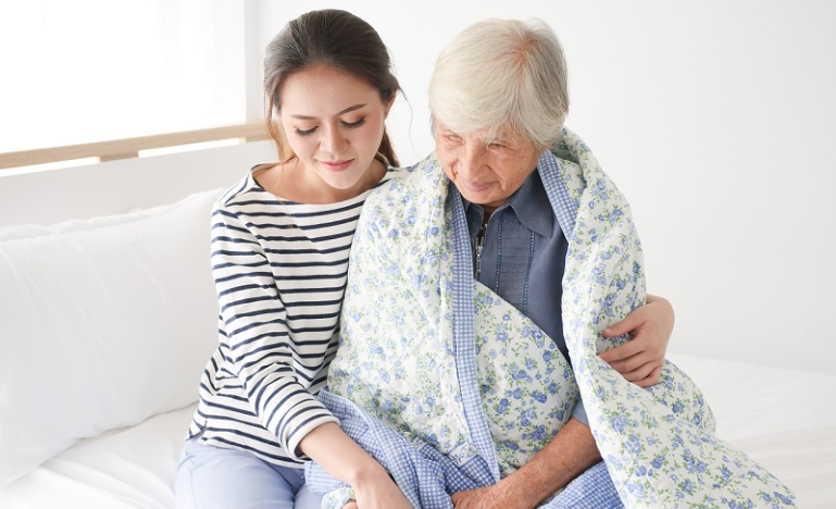 Young lady assists an older lady