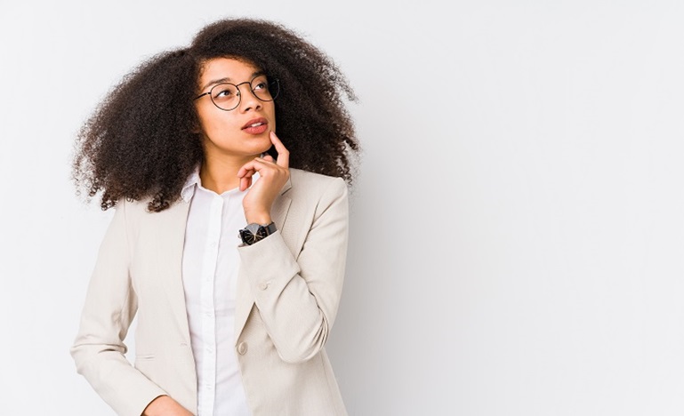 Young Black professional woman with long hair striking a ponderous pose