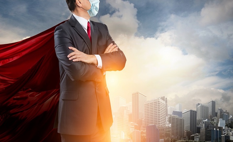 Man in a suit and mask with a red cape