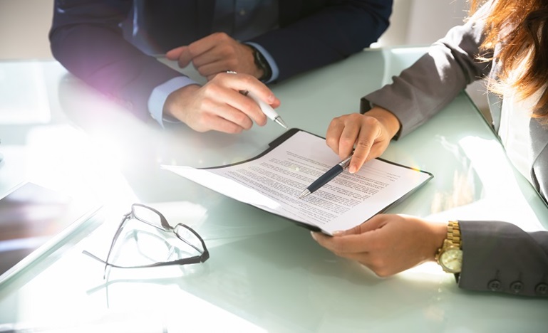 a woman and man review a legislative document
