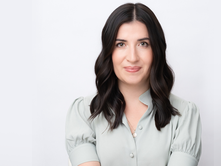Head-shot photo of OBA President Katy Commisso in light grey, short-sleeved blouse, smiling into camera