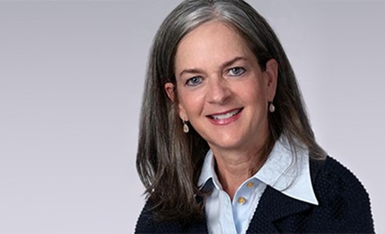 photo of Commissioner Kelly Burke, smiling with head tilted slightly to the right