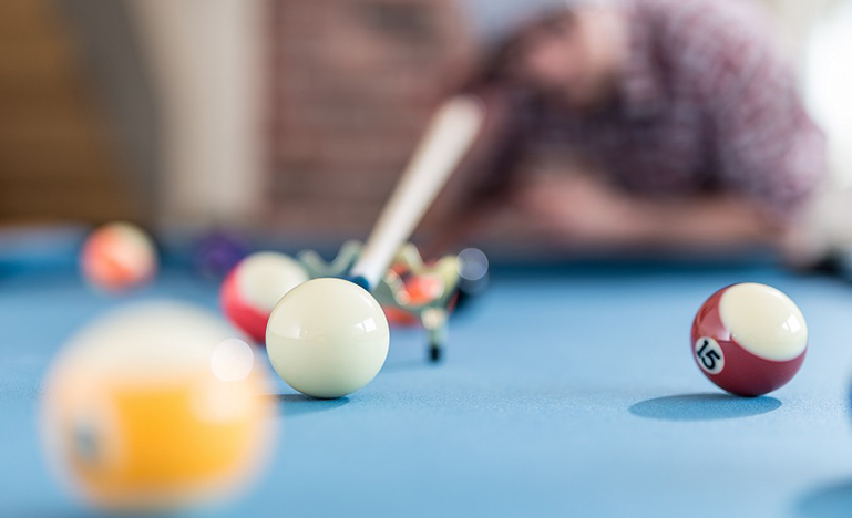 Billiard table, person lining up a shot